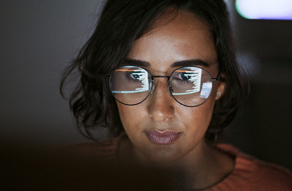 woman looking into computer