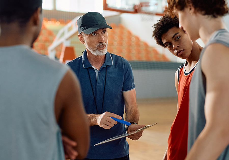 basketball coach giving instructions to team