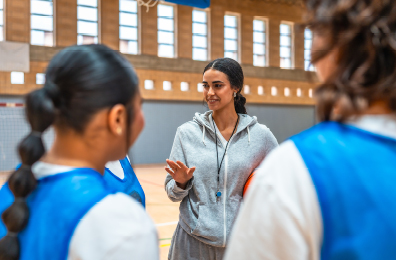 Coach talking to her players indoors