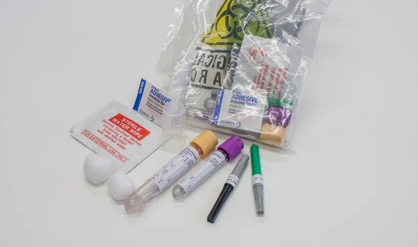 A blood testing kit with vials, swabs, cotton buds and a sealed collection bag, for athlete anti-doping testing