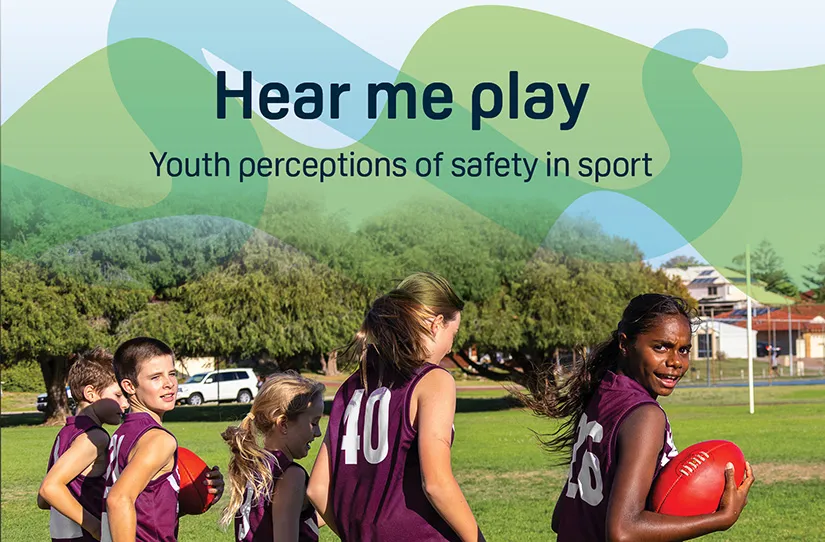 Young Australian rules footballers in purple uniforms on the ground with footballs in hand 
