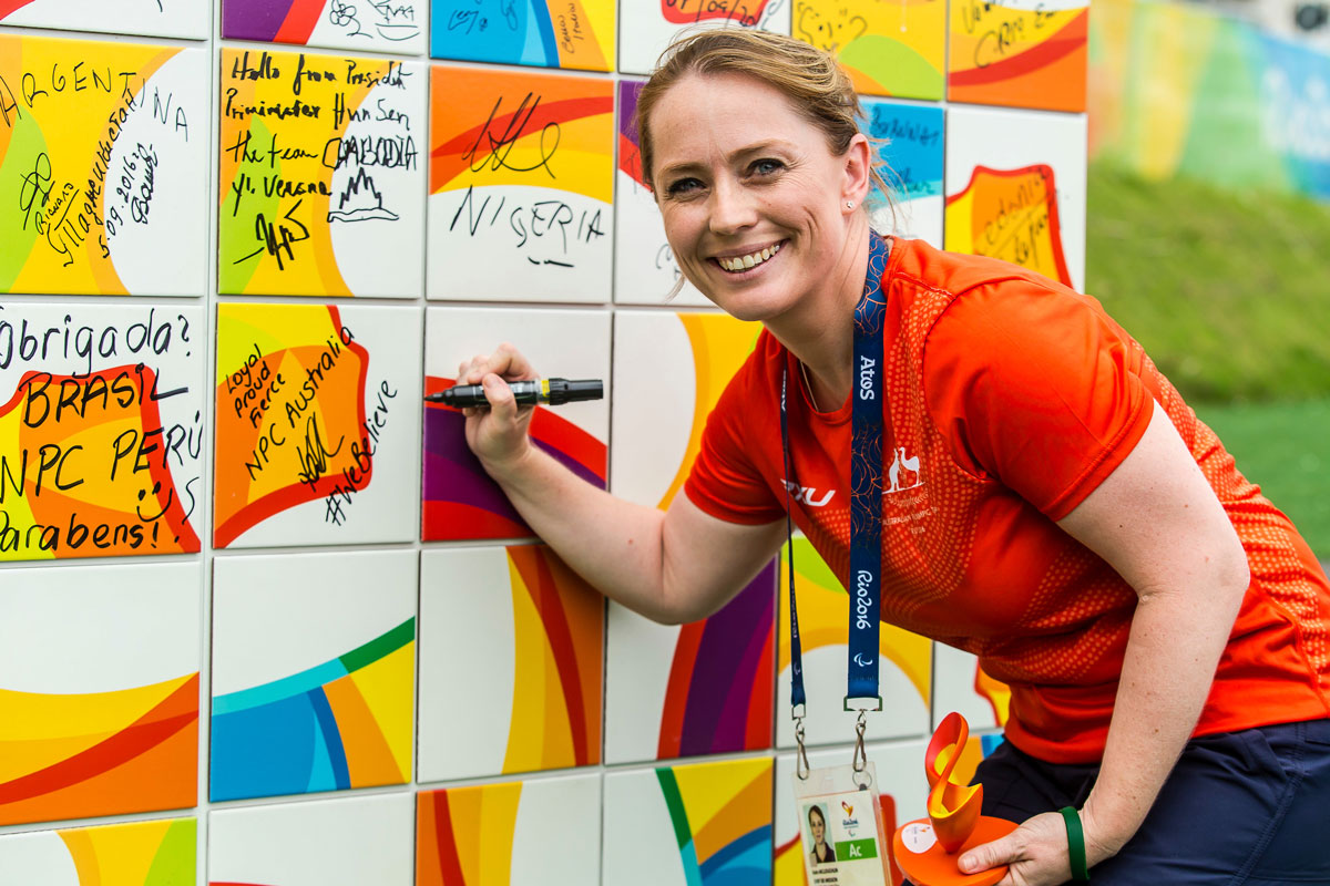 Kate McLoughlin signing a wall at the Rio 2016 Paralympics as the first female Chef de Mission