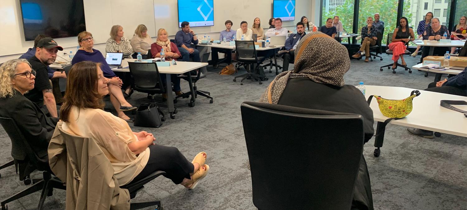 Course attendees from 32 Victorian State Sport Associations shown participating in a panel discussion group. The panel is pictured from the back and is facing the group.