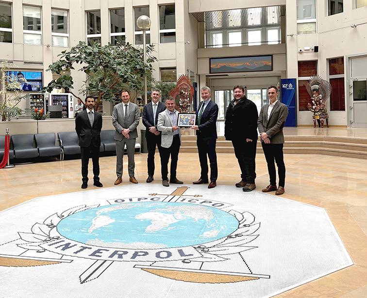 INTERPOL secondment group photo with David Sharpe and Darren Mullaly at INTERPOL's headquarters in France