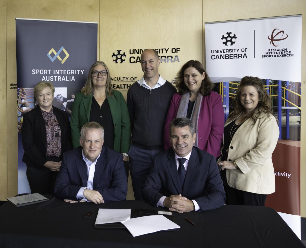 Photos of attendees at the signing of a joint PhD research project on cyberbullying