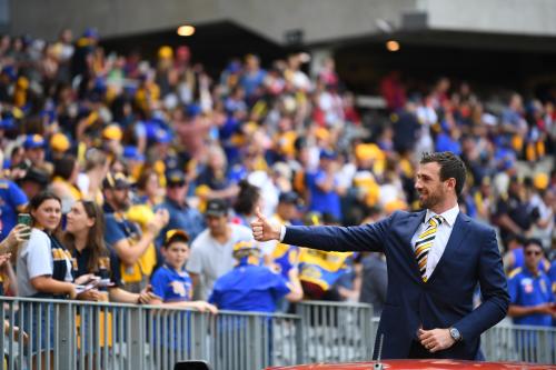 Eric Mackenzie farewells crowd during lap of honour after retiring from the AFL