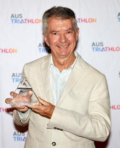 Dave Williams holding his John Ison Award glass trophy