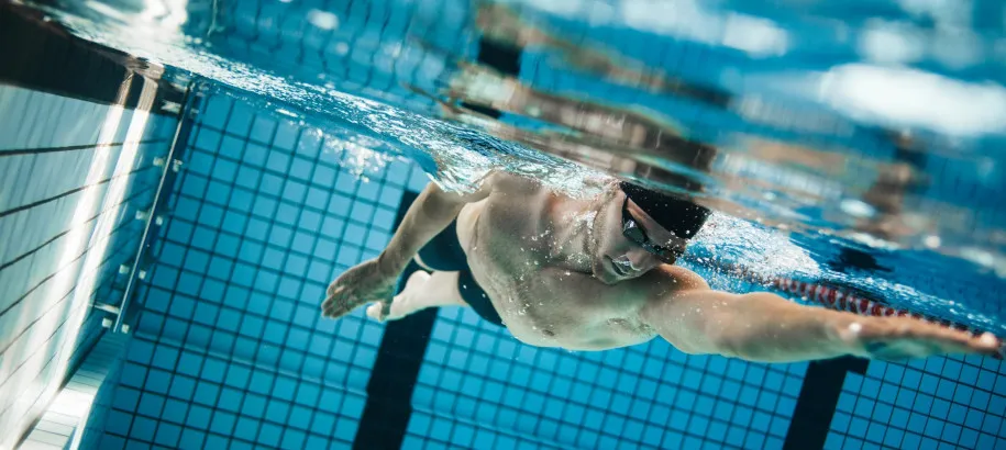 Swimming athlete takes a stroke underwater