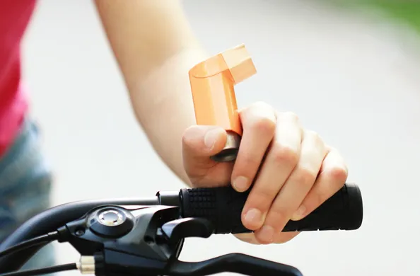 Person holding puffer on a bike