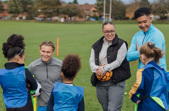 Coach and parents talking to kids