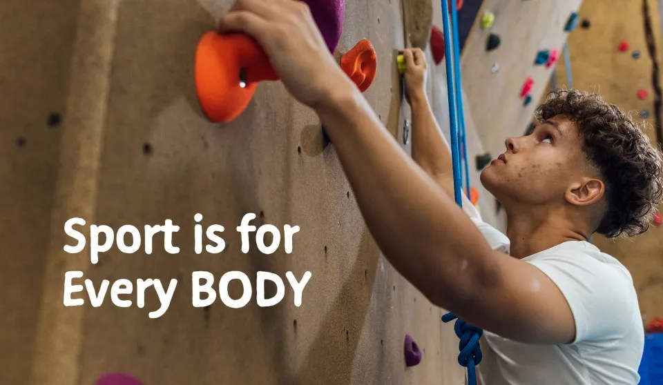Young person climbs indoor rock climbing wall - Sport is for every BODY campaign