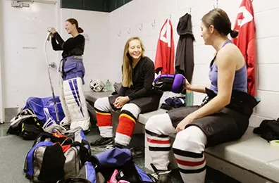 Girls ice hockey team getting dressed in the change room
