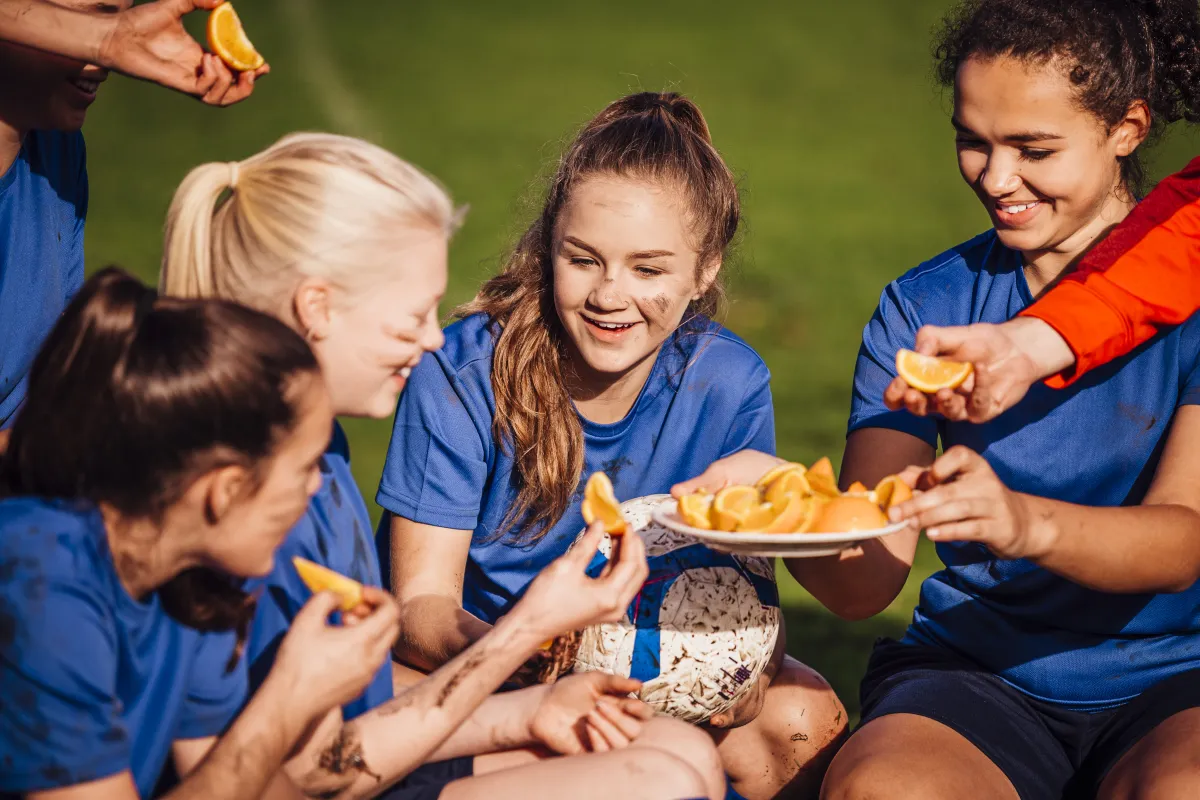 Football team eating oranges