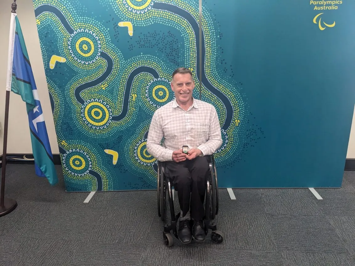 Sport Integrity Australia Sports Partnership Manager Richard Nicholson, now officially the 527th Paralympian, with his commemorative Paralympic Pin.