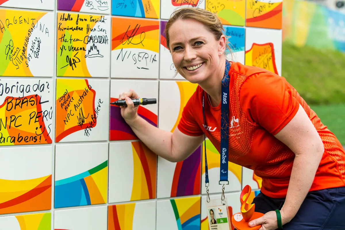 Kate McLoughlin signing a wall at the Rio 2016 Paralympics as the first female Chef de Mission