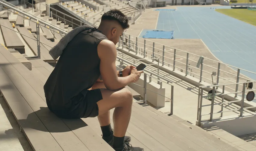 Person contacting the Safe Sport Hotline on mobile phone after training