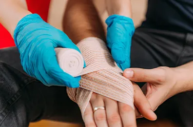 bandage being wrapped around hand