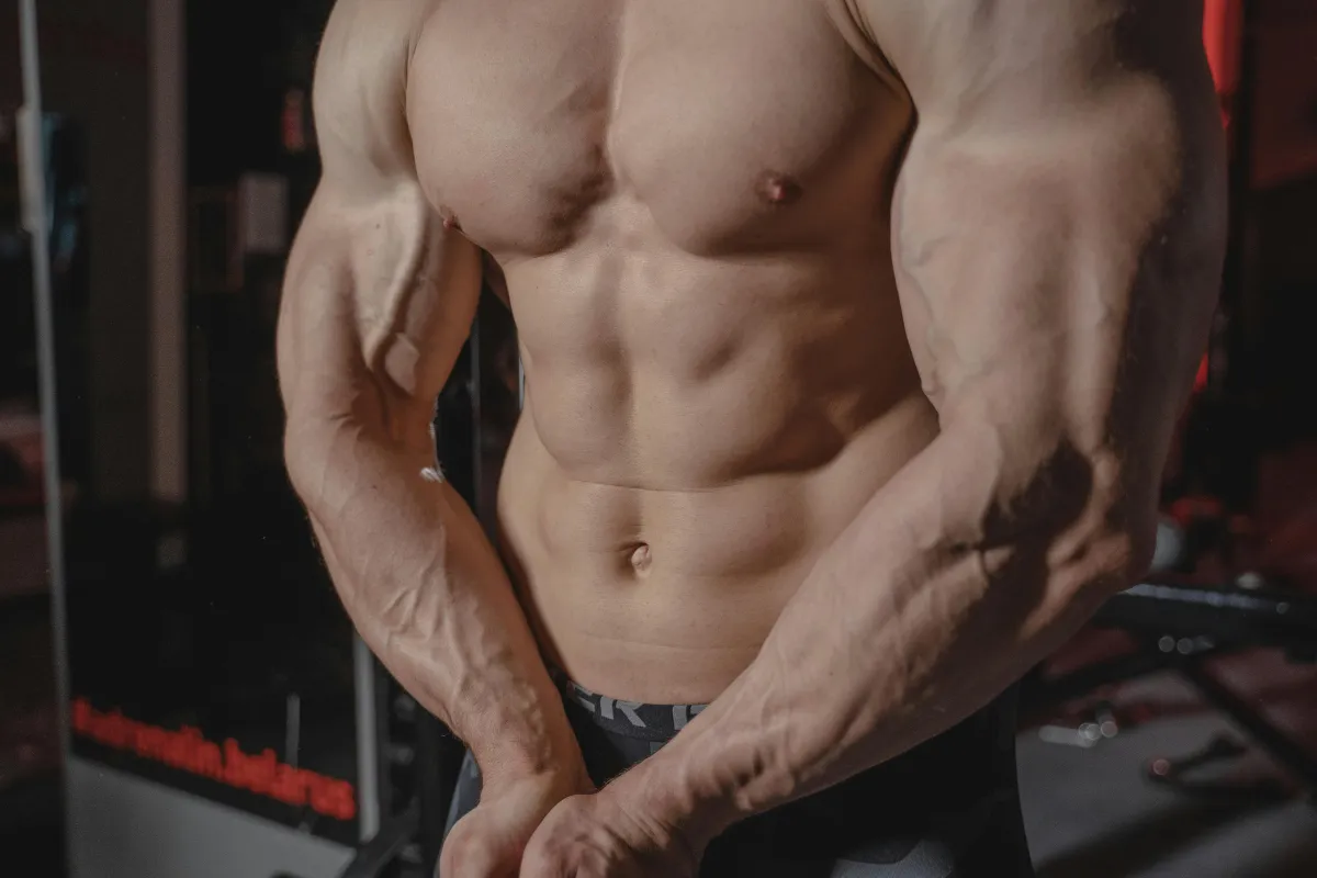 Young male flexing his muscles with shirt off
